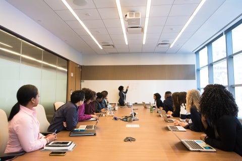 People working at a conference table. 